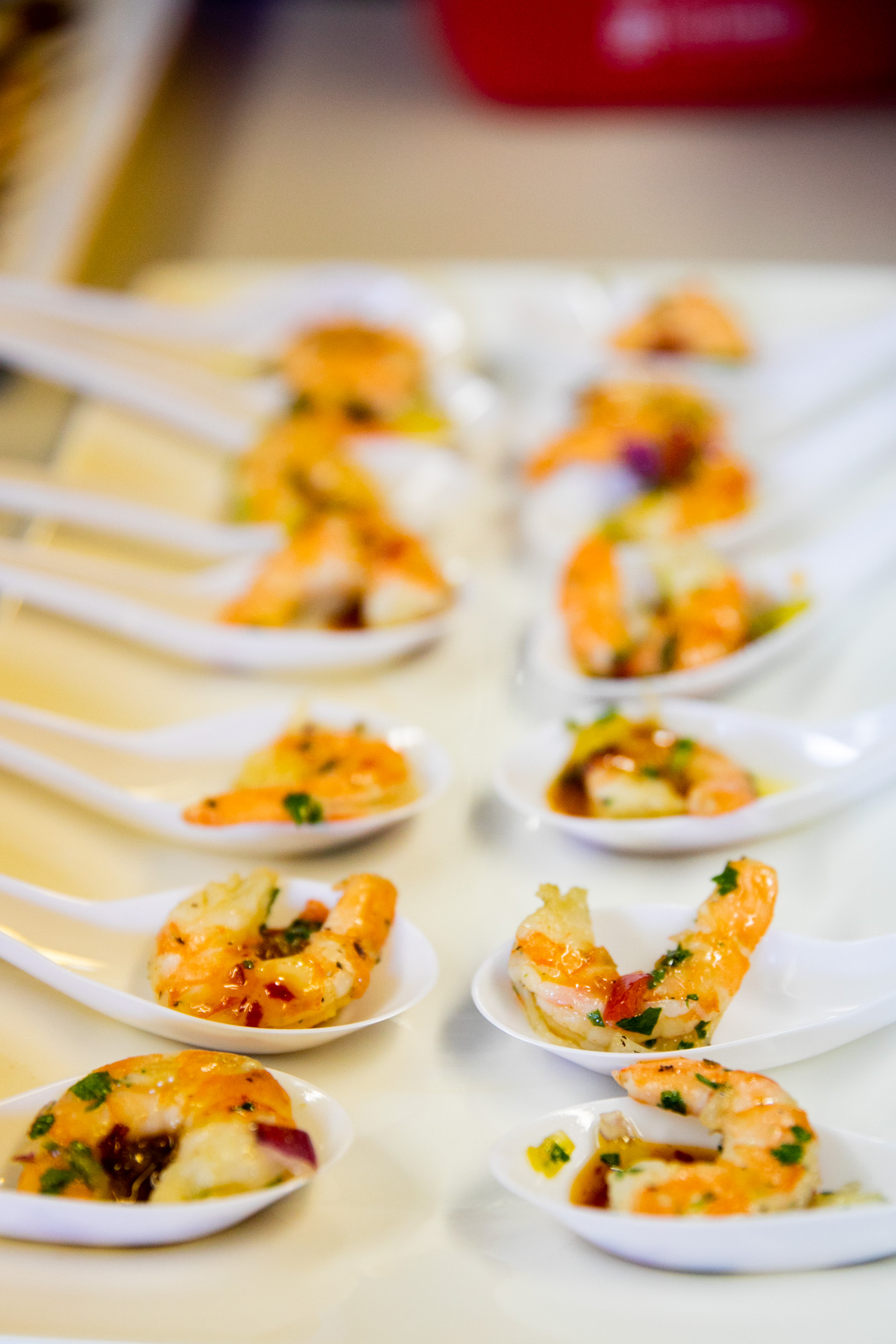 Wedding catering shrimp appetizers in spoons.